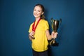 Excited girl with medals and trophy cup Royalty Free Stock Photo