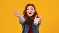 Excited Girl Shouting Stretching Hands To Camera On Yellow Background