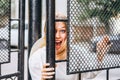 Excited woman on the street behind the gates Royalty Free Stock Photo