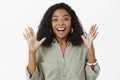 Excited girl about to tell amazing news. Thrilled talkative happy african american woman with curly hairstyle in trendy