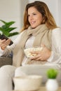 excited girl watching tv eating popcorns Royalty Free Stock Photo