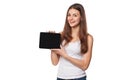 Excited girl in white shirt showing tablet pc monitor. Smiling woman with tablet pc, isolated on orange background