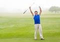 Excited golfer cheering on putting green Royalty Free Stock Photo