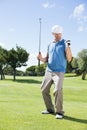 Excited golfer cheering on putting green Royalty Free Stock Photo