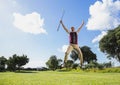 Excited golfer jumping up holding club Royalty Free Stock Photo