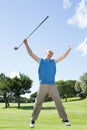 Excited golfer jumping up and smiling at camera Royalty Free Stock Photo