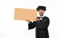 Excited graduate male students wearing toga holding blank space carton