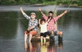 Excited grandfather, father and son are fly fishing on river. Royalty Free Stock Photo