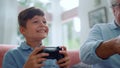 Excited grandson playing video game with grandfather at home Royalty Free Stock Photo