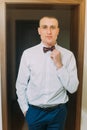 Excited groom posing standing in doorcase of hotel room Royalty Free Stock Photo