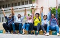 Excited group of students shouting by holding eachother hands after exams at on college campus - concept of friendship Royalty Free Stock Photo