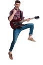 Excited guitarist jumping and making rock on sign during concert Royalty Free Stock Photo