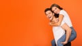 Excited guy giving piggyback ride to his girlfriend Royalty Free Stock Photo