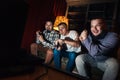 Excited guys play video game on couch at home Royalty Free Stock Photo