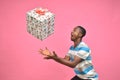 excited handsome young back man holding catching gift boxes Royalty Free Stock Photo