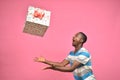 excited handsome young back man holding catching gift boxes Royalty Free Stock Photo