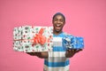 excited handsome young back man offering presents to viewers Royalty Free Stock Photo