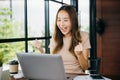 Excited happy Asian business young woman sitting with laptop computer Royalty Free Stock Photo