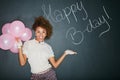 Excited, happy birthday balloons and portrait of a model and chalkboard for celebration. Happy, smile and excited person Royalty Free Stock Photo