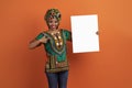 Excited traditional african woman holding white blank placard