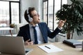 Excited happy funny businessman in wireless headphones listening to music Royalty Free Stock Photo