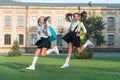 Excited happy girls school uniform running, hurry up concept