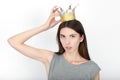 Excited happy looking woman wearing a handmade princess crown. Closeup of happy mixed race asian caucasian female model isolated o