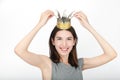 Excited happy looking woman wearing a handmade princess crown. Closeup of happy mixed race asian caucasian female model isolated o