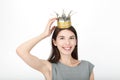 Excited happy looking woman wearing a handmade princess crown. Closeup of happy mixed race asian caucasian female model isolated o