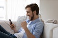 Excited happy man using mobile phone, getting surprising good news Royalty Free Stock Photo