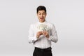 Excited and happy, pleased handsome asian businessman made good deal, counting money and smiling thrilled, winning bid Royalty Free Stock Photo