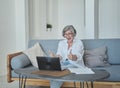 Excited happy senior woman is actively rejoicing winning the online lottery, mortgage approval Royalty Free Stock Photo