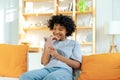 Excited happy young black african american woman holding cell phone laughing feeling joy getting mobile message Royalty Free Stock Photo