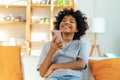 Excited happy young black african american woman holding cell phone laughing feeling joy getting mobile message Royalty Free Stock Photo