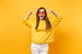 Excited happy young woman in fur sweater and heart orange glasses pointing index fingers on head isolated on bright Royalty Free Stock Photo