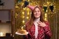 Excited happy young woman holding cake and keeping hand on her chest, touched with sincere cordial toast on her birthday Royalty Free Stock Photo