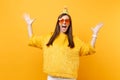 Excited happy young woman in orange heart glasses, birthday party hat spreading hands, enjoying holiday, celebrating