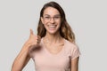 Excited happy young woman wearing glasses showing thumbs up Royalty Free Stock Photo