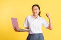 excited high school girl with fists clenched using a laptop