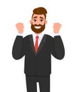 Excited hipster business man gesturing or showing raised hand fist. Trendy stylish person celebrating success with lifted arms. Royalty Free Stock Photo