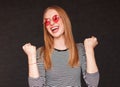 Excited hipster woman with fists up