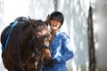 Excited for horse riding. An attractive woman laughing outside while standing outside with her horse. Royalty Free Stock Photo