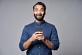 Excited indian business man using mobile phone isolated on gray background. Royalty Free Stock Photo