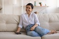 Excited Indian young woman using smartphone, making easy internet payment