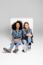 excited interracial children in denim clothes