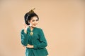 excited javanese woman in green kebaya standing with pointed finger