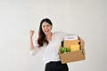 Excited and joyful Asian female office worker showing her fist, celebrating her resignation Royalty Free Stock Photo