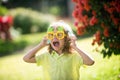 Excited kid boy with headphones and funny sunglasses. Portrait of kid boy in nature, park or outdoors. Close up face of Royalty Free Stock Photo