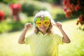 Excited kid boy with headphones and funny sunglasses. Portrait of kid in spring park outdoors. Close-up face child Royalty Free Stock Photo