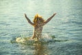 Excited kid boy playing and having fun on the beach on blue sea in summer. Blue ocean with wawes. Child boy swimming in Royalty Free Stock Photo